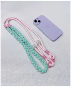 Detailed view of hand-woven pastel phone lanyard with iridescent beads on white background