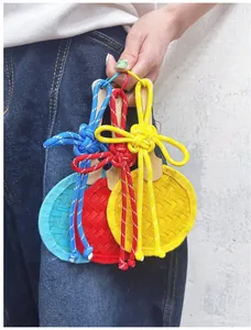Detailed view of handmade colorful bamboo woven mini fan pendants with traditional knots.