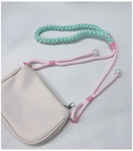 Detail of handmade braided crossbody strap with colorful dopamine style and small pouch