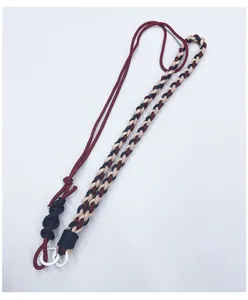 Detail view of multi-colored hand-woven adjustable paracord crossbody phone strap
