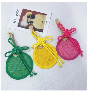 Handmade bamboo woven fan pendants with colorful Chinese knots in green, yellow and pink.