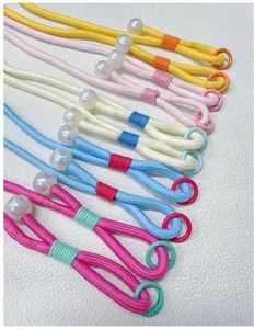 Detail of colorful hand-woven crossbody phone lanyards with decorative pearl beads