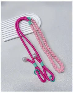 High-quality detail of hand-woven pink dopamine style crossbody phone strap with beads