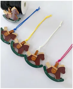 Handmade leather rocking horse bag charms with colorful cords for cute accessories