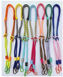 Detailed macro view of multiple hand-woven colorful crossbody rope straps for phones or cameras