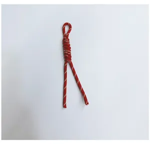 Detailed view of handmade red braided lanyard strap with white dot pattern accessory