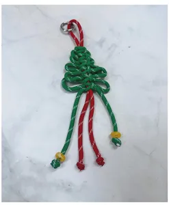 Vista dettagliata del ciondolo a forma di albero di Natale in paracord intrecciato.