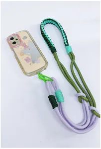 Close-up view of a handmade woven crossbody phone lanyard strap in green and purple