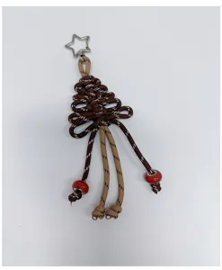 Detailaufnahme eines handgeflochtenen Weihnachtsbaum-Schlüsselanhängers mit Sternring.