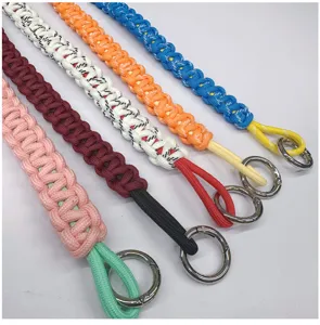 Detailed view of colorful hand-woven paracord wrist straps with sturdy silver metal rings