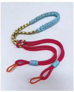 Detailed view of a hand-woven colorful rope lanyard with bright orange carabiner clips.