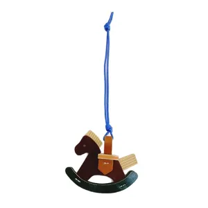 Handmade rocking horse bag charm crafted from brown leather and wood for bag decoration