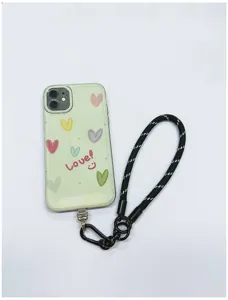 Detail view of a black braided phone lanyard wrist strap attached to a cute heart phone case