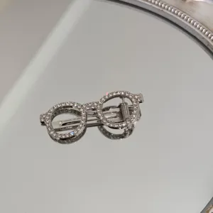 Sparkling rhinestone eyeglasses hair clip detail showing silver finish and crystal gems.