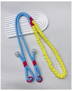 Detailed view of a hand-woven colorful dopamine style crossbody phone lanyard strap