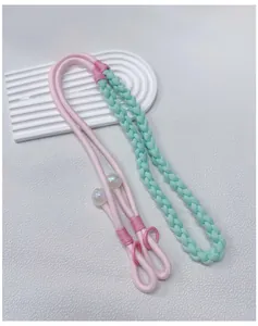 Detailed view of handmade braided pink and mint green crossbody phone lanyard strap