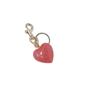 Premium sparkly pink heart-shaped keychain with gold-toned lobster clasp for bag decoration