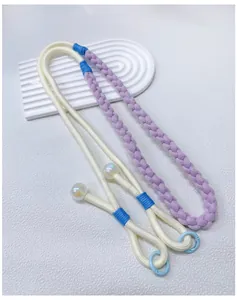 Detailed view of handwoven adjustable phone lanyard in purple and cream dopamine colors