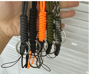 Five different colored braided paracord lanyards held in hand for size comparison