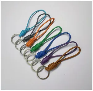 Detailed macro view of colorful handmade braided wax rope keychains with metal rings