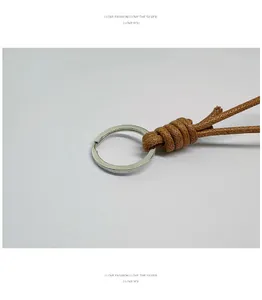 Macro view showing the intricate knot of a hand-woven brown wax rope keychain set