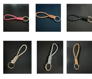 Selection of hand-woven rope keychains in six distinct colors on a dark background.