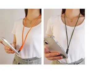 Detailed view of hand-braided phone lanyards in orange and green worn by a model