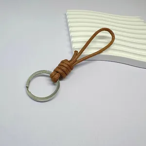 Minimalist hand-braided brown wax rope keychain with silver metal ring for keys