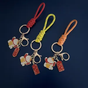 Handmade braided wrist strap keychain with lucky cat charms and blessing tablets