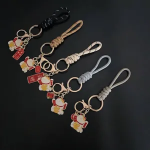 Hand-woven Maneki-neko lucky cat keychain featuring a stylish braided rope wrist strap