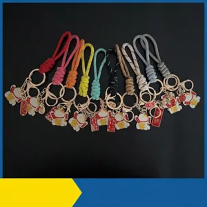 Hand-woven colorful paracord wristlet keychains with lucky cat charms in various colors.