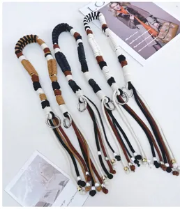 Detail showing four multi-colored handmade woven cotton rope bag straps with metal rings.