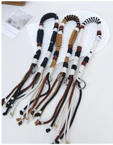 Detailed view of handmade woven cotton rope bag straps with colorful patterns and silver rings