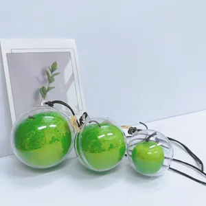 Set of three creative artificial green apple hanging ornaments in clear plastic spheres