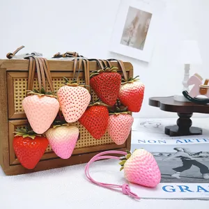 Lifelike 3D strawberry bag charm with leather strap available in multiple vibrant colors