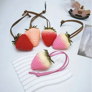 Large realistic strawberry bag charms in various colors featuring leather straps and 3D design