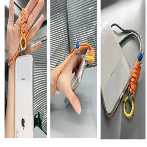 Detailed view of an adjustable orange braided paracord phone wrist strap on a mobile device