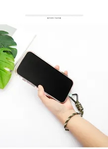 Detailed view of a camouflage paracord wrist lanyard attached to a clear phone case
