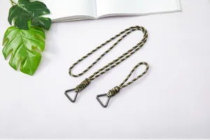 Close-up detail of hand-woven camouflage paracord lanyard with black triangle carabiner clip