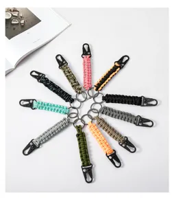 Variety of hand-woven paracord keychains with metal eagle beak buckles.