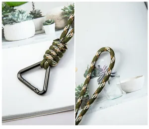 Close-up detail of army green woven paracord wrist lanyard with a triangle metal carabiner