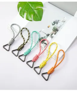 Detailed view of colorful braided paracord keychains with triangle metal buckles on white