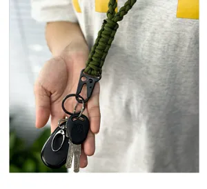 Close-up detail of heavy-duty olive green paracord neck lanyard holding keys and fob.