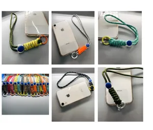 Adjustable braided phone wrist straps in multiple colors attached to mobile phones