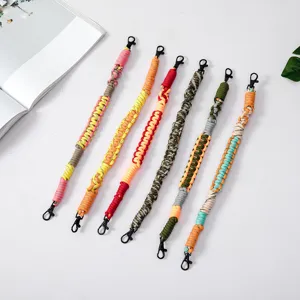 Six colorful handmade woven paracord lanyards for phones and keys with metal clips