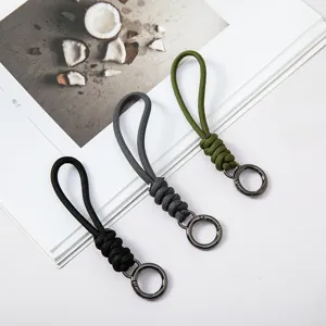Hand-woven paracord keychains with durable metal spring rings in black, grey, and olive green
