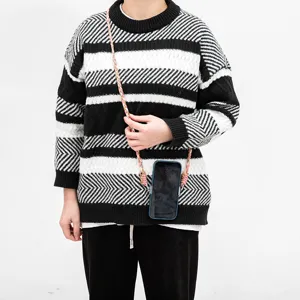 Universal braided crossbody phone strap lanyard on model with black and white sweater
