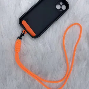 Bright orange braided phone lanyard strap with black metal clip shown on a black case