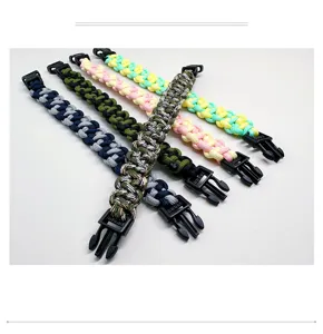Detail view of five colorful braided 7-core paracord survival bracelets with black buckles.