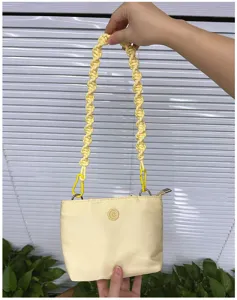Detailed view of hand-woven yellow rope shoulder strap for crossbody and underarm bags